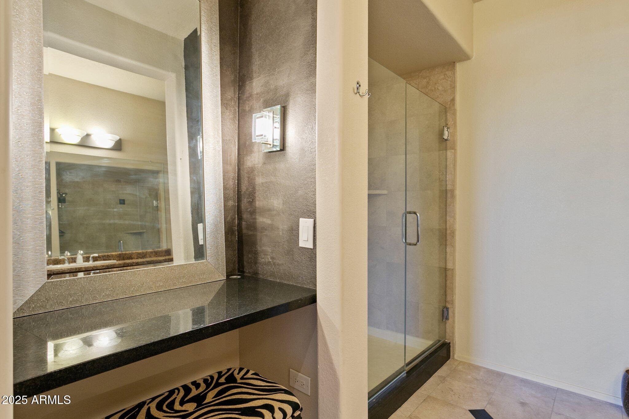 9820 North Central Avenue, Unit 317 Phoenix, AZ 85020 - Photo 12 of 26 a bathroom with a glass door shower and a sink