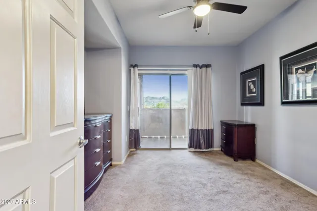 an empty room with windows and cabinet