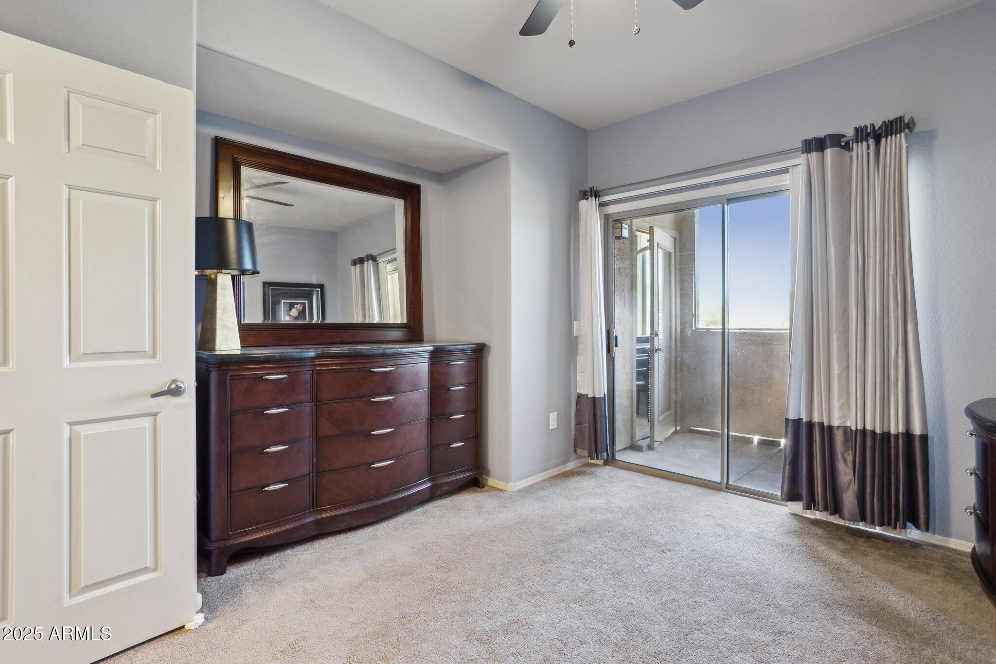 9820 North Central Avenue, Unit 317 Phoenix, AZ 85020 - Photo 15 of 26 an empty room with a mirror and a dresser