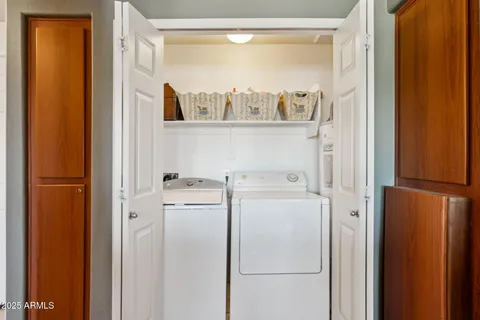 a view of washer and dryer with kitchen in the background