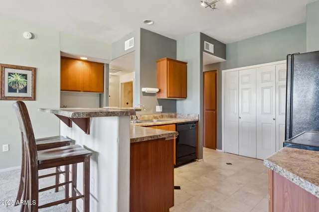 a bathroom with a granite countertop sink a mirror and a shower