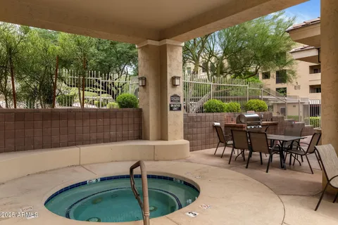 a view of a patio with table and chairs and potted plants