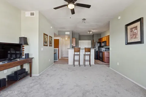 a view of kitchen with furniture and a ceiling fan