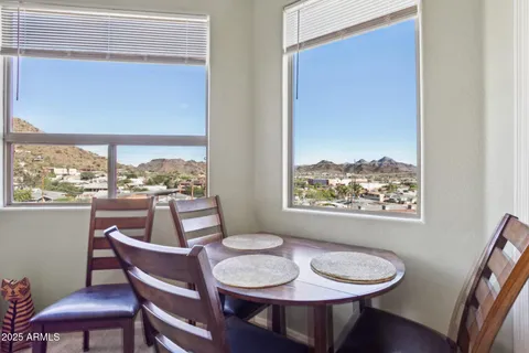 a dining room with furniture a rug and wooden floor