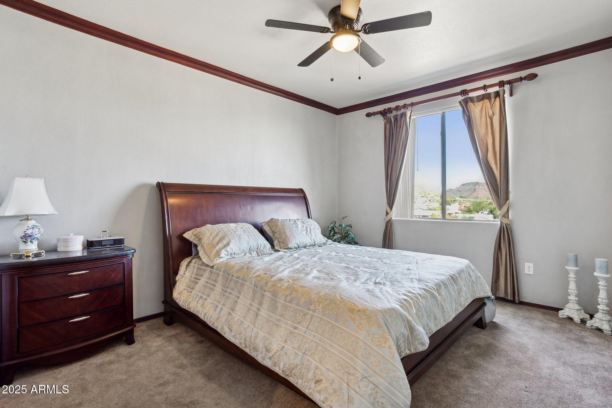 9820 North Central Avenue, Unit 317 Phoenix, AZ 85020 - Photo 9 of 26 a bedroom with a bed and a window