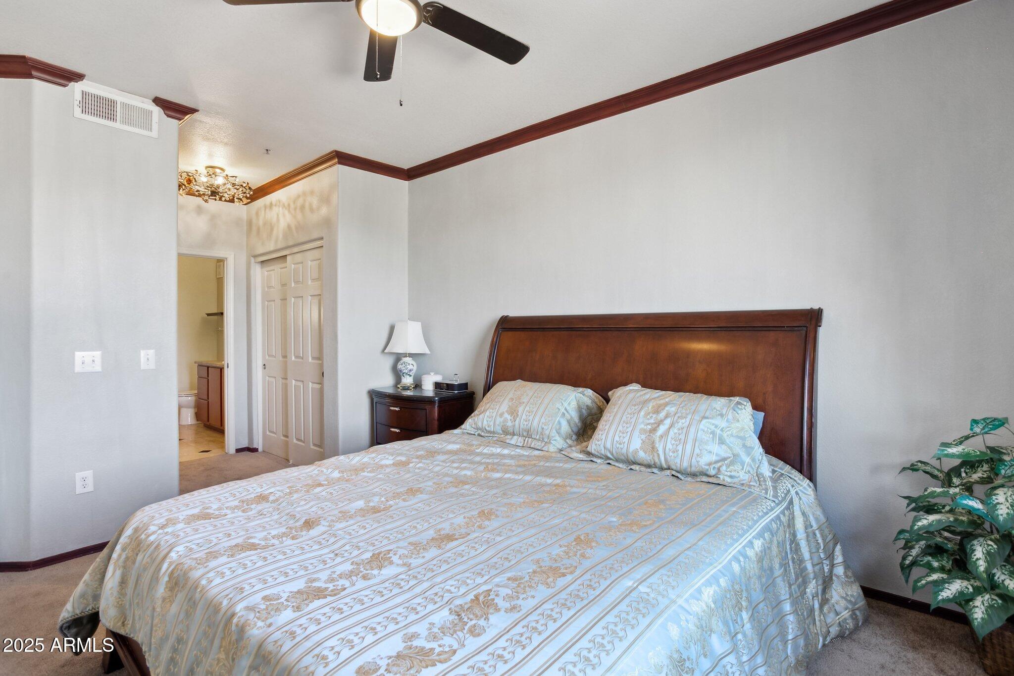 9820 North Central Avenue, Unit 317 Phoenix, AZ 85020 - Photo 10 of 26 a bedroom with a bed and a ceiling fan