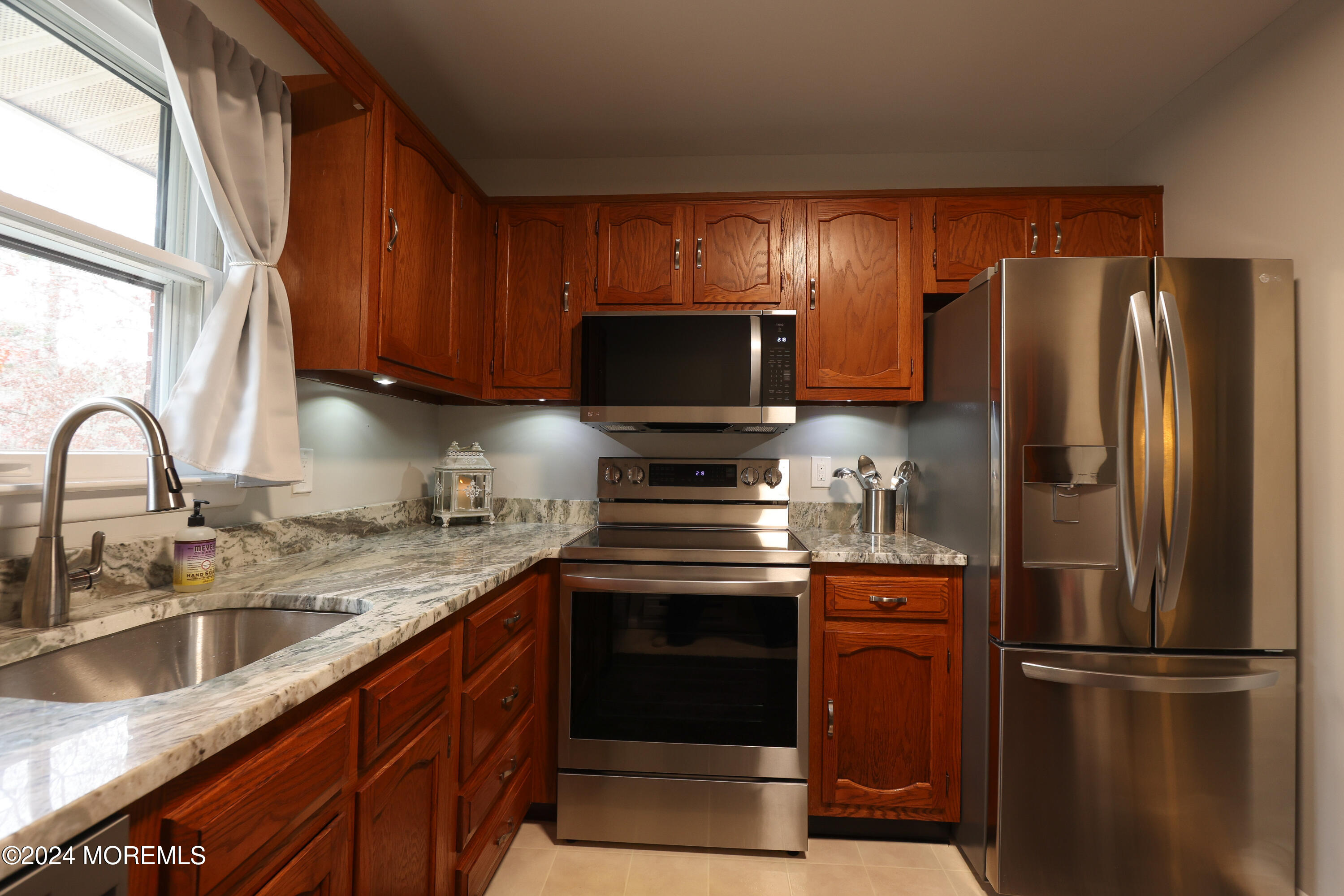 20 Cranberry Road, Unit 8 Manahawkin, NJ 08050 - Photo 18 of 42 a kitchen with stainless steel appliances granite countertop a refrigerator stove and sink