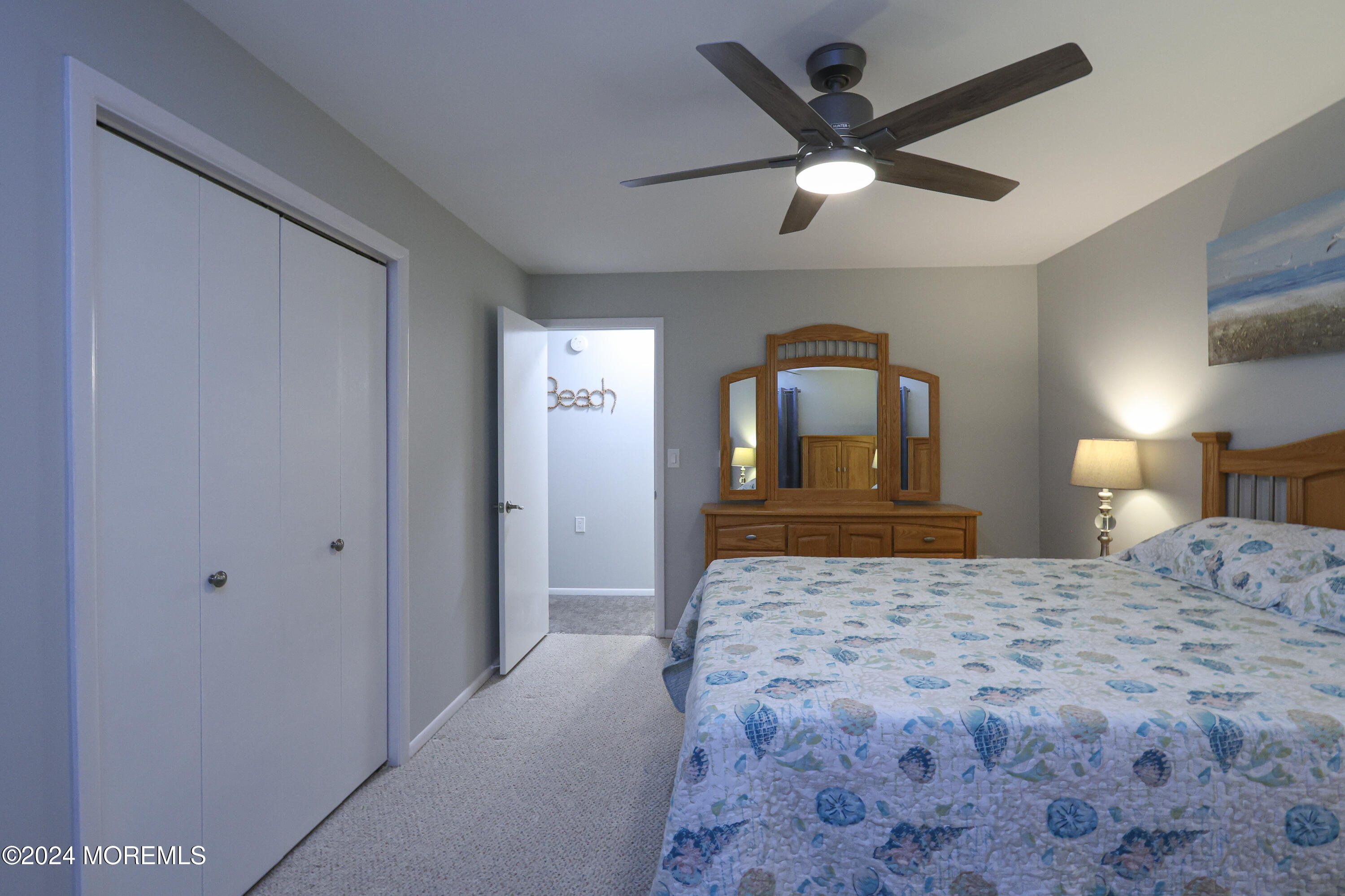 20 Cranberry Road, Unit 8 Manahawkin, NJ 08050 - Photo 26 of 42 a bedroom with a large bed and a chandelier