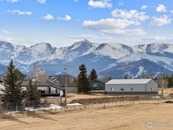 a view of a house with a snow yard and mountain view