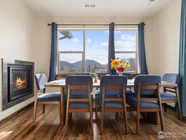 a view of a dining room with furniture a chandelier and wooden floor