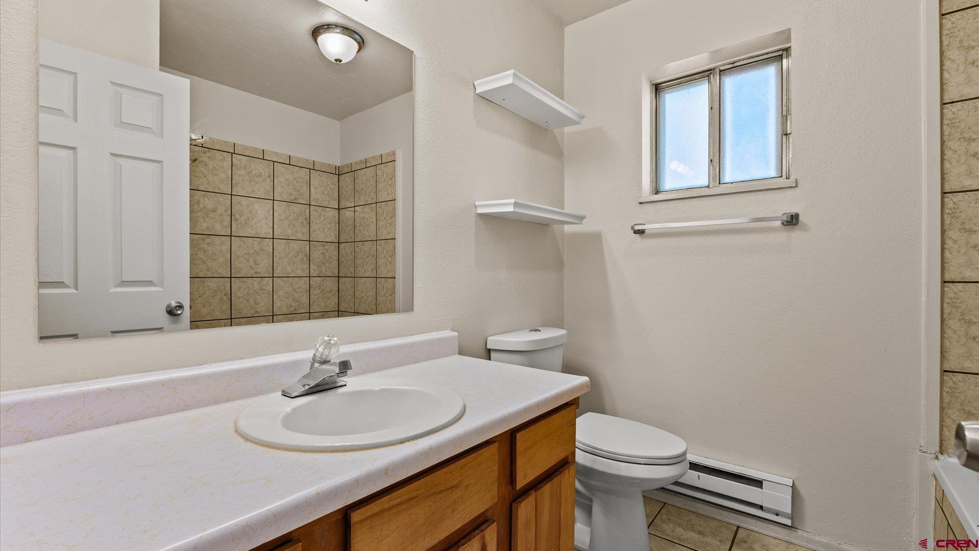 535 Labor Street Delta, CO 81416 - Photo 12 of 15 a bathroom with a sink a toilet and mirror