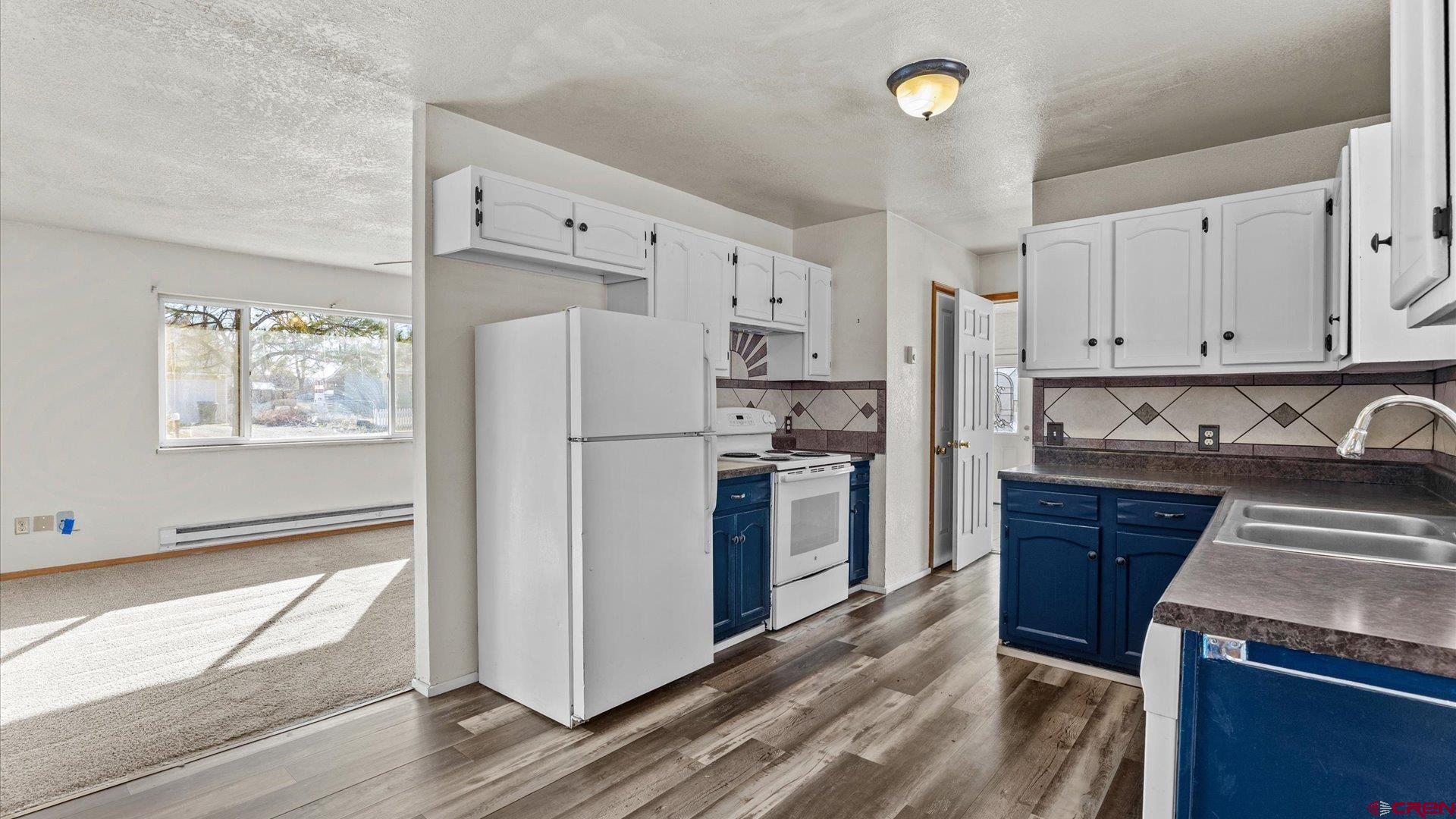 535 Labor Street Delta, CO 81416 - Photo 2 of 15 a kitchen with stainless steel appliances granite countertop a refrigerator sink and stove