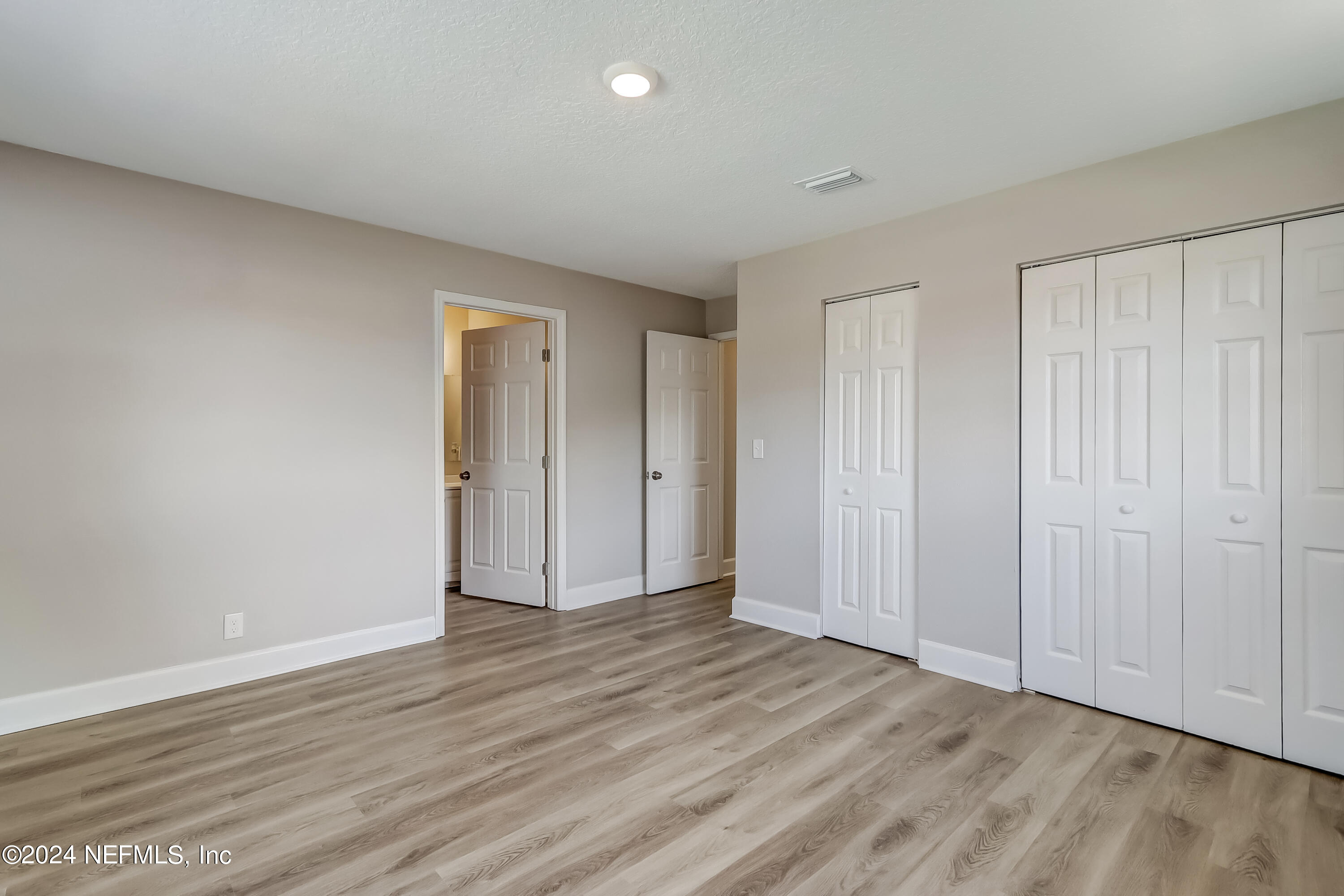 327 Neptune Road Orange Park, FL 32073 - Photo 14 of 40 a view of an empty room and wooden floor