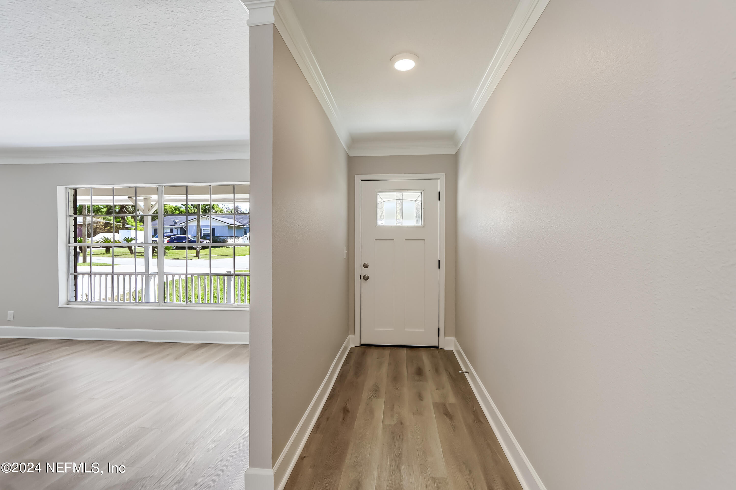 327 Neptune Road Orange Park, FL 32073 - Photo 2 of 40 a view of a room with wooden floor and a window