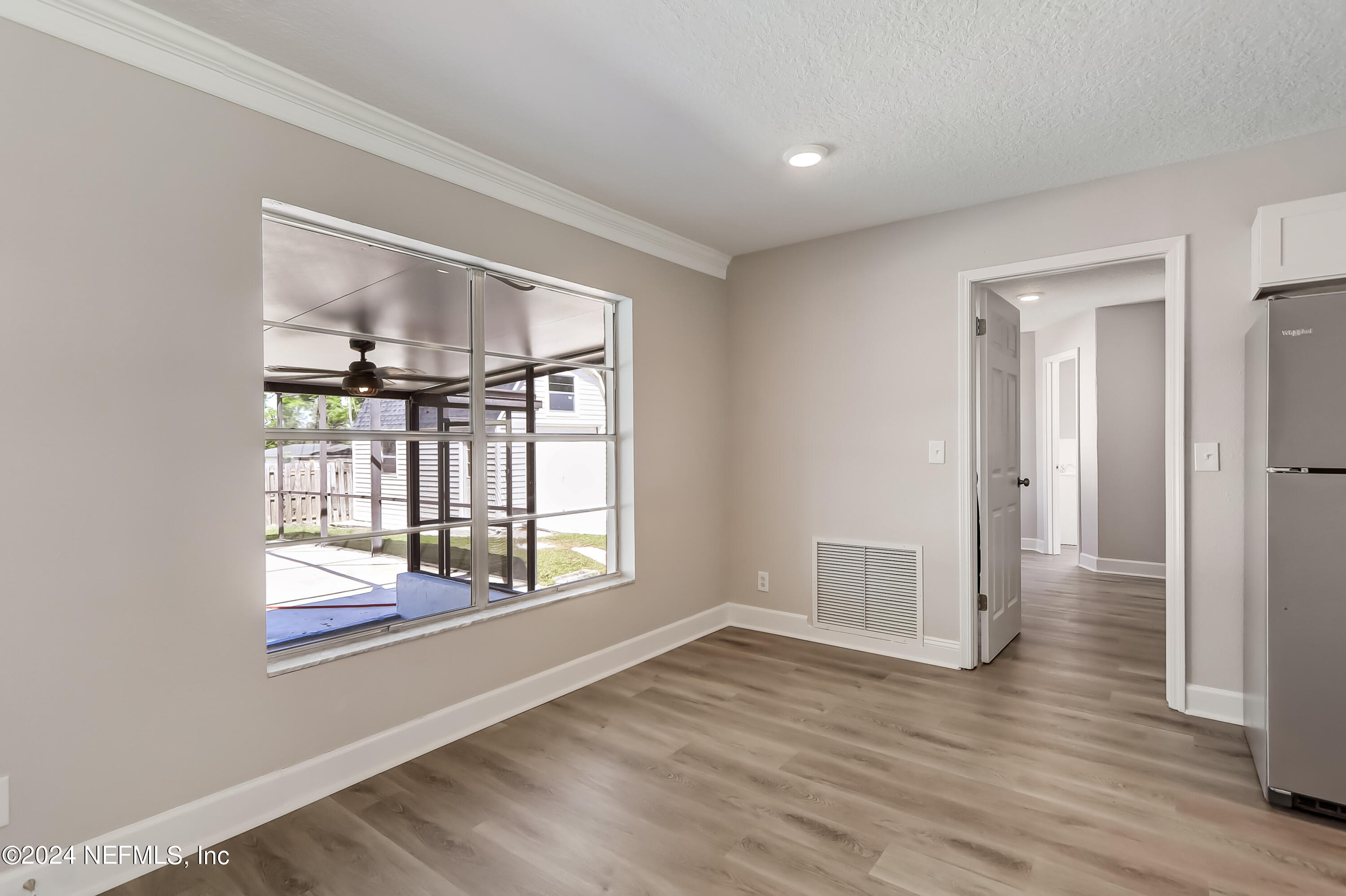327 Neptune Road Orange Park, FL 32073 - Photo 23 of 40 wooden floor in an empty room with a window