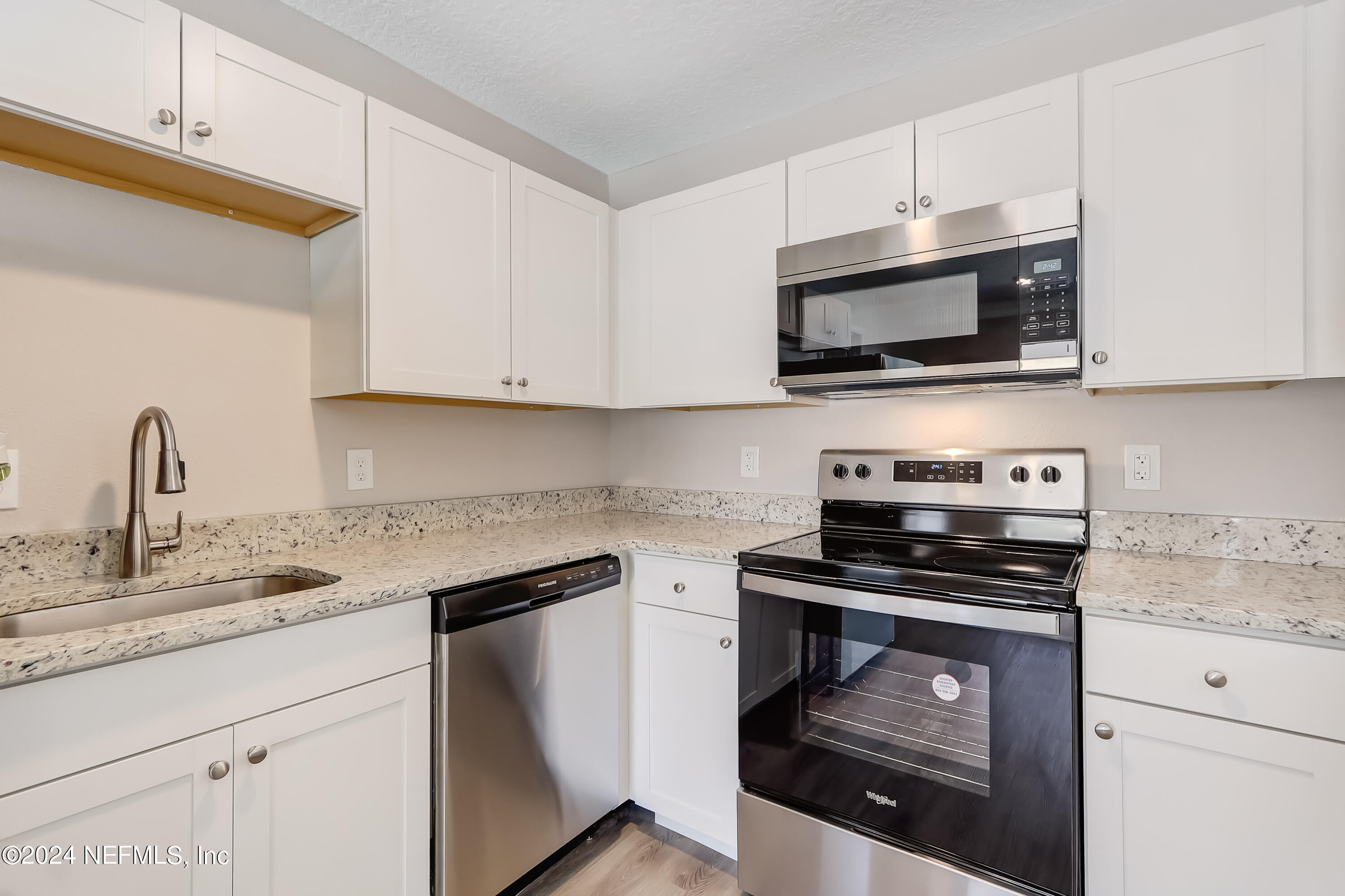327 Neptune Road Orange Park, FL 32073 - Photo 26 of 40 a kitchen with cabinets stainless steel appliances and a sink