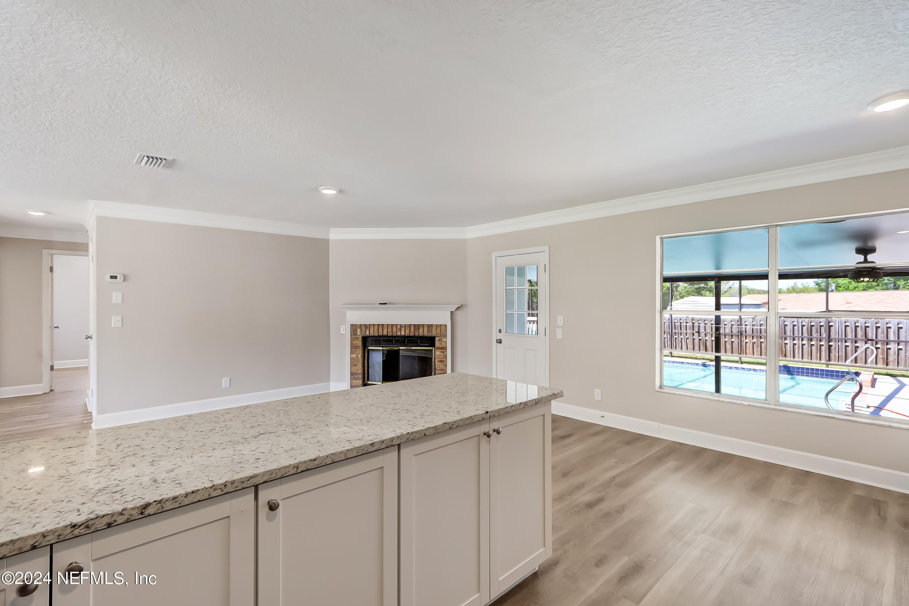 327 Neptune Road Orange Park, FL 32073 - Photo 27 of 40 a view of an empty room with glass door and wooden floor