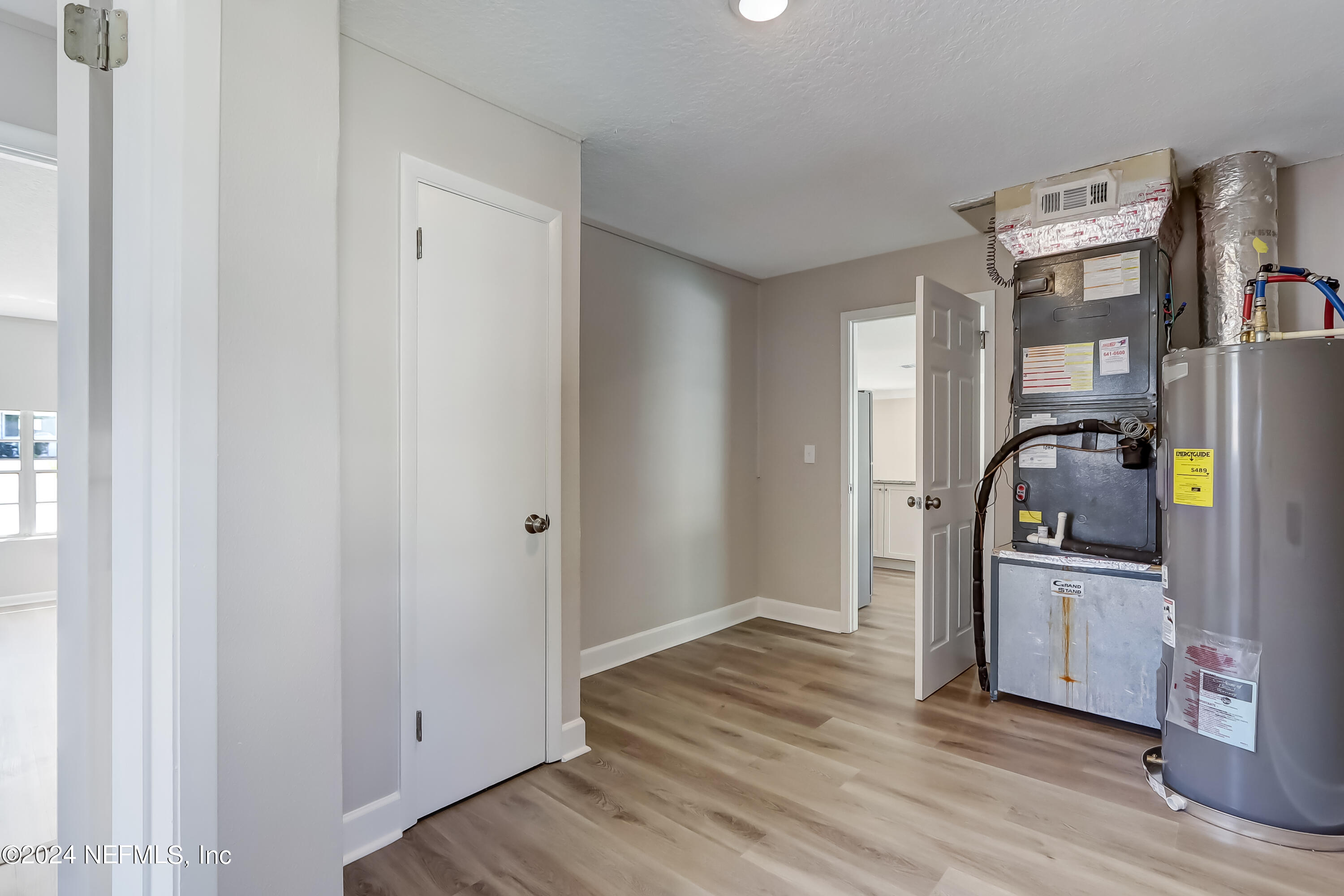 327 Neptune Road Orange Park, FL 32073 - Photo 28 of 40 a view of a kitchen with refrigerator and wooden floor