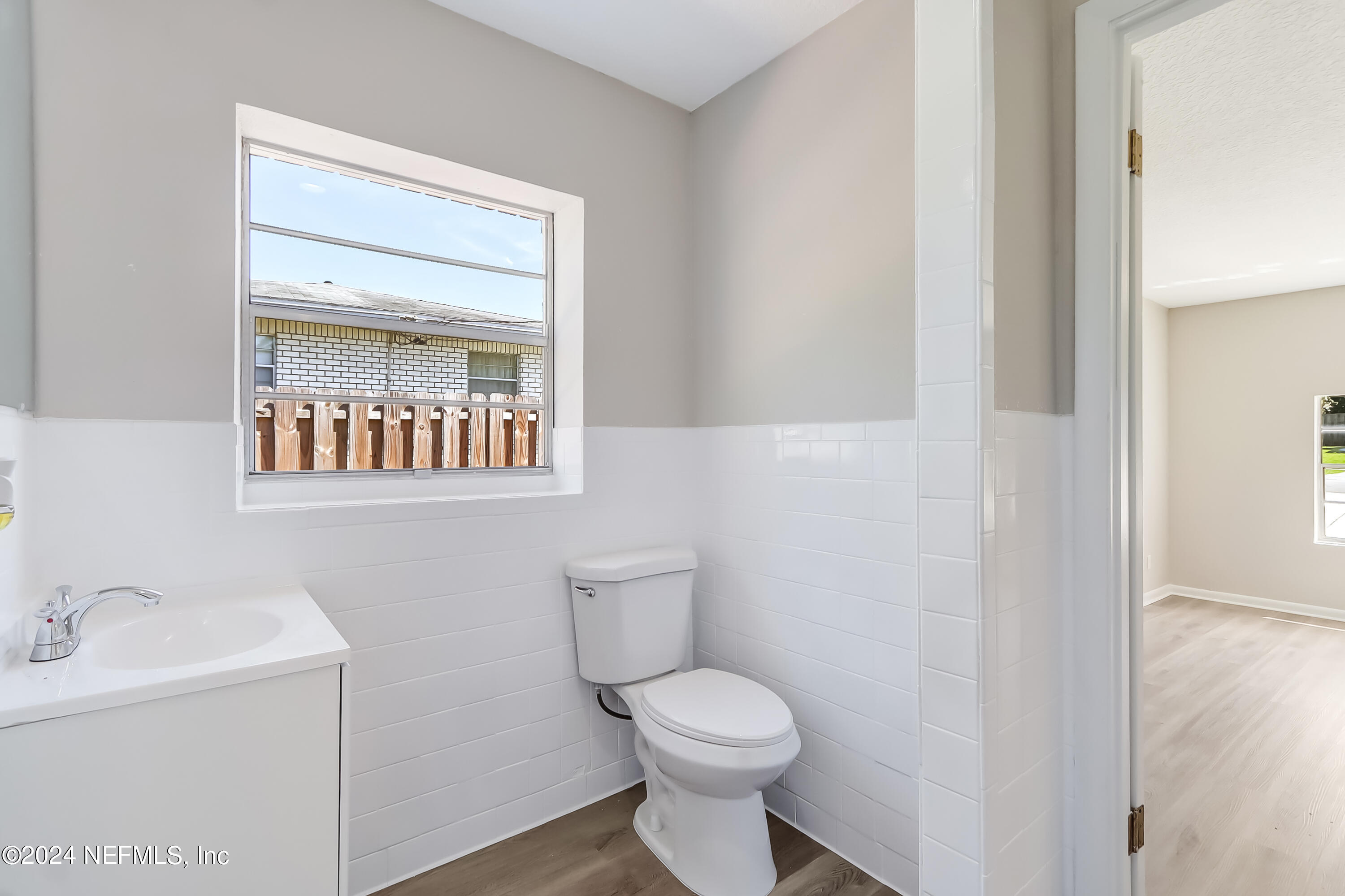 327 Neptune Road Orange Park, FL 32073 - Photo 29 of 40 a bathroom with a toilet sink and mirror