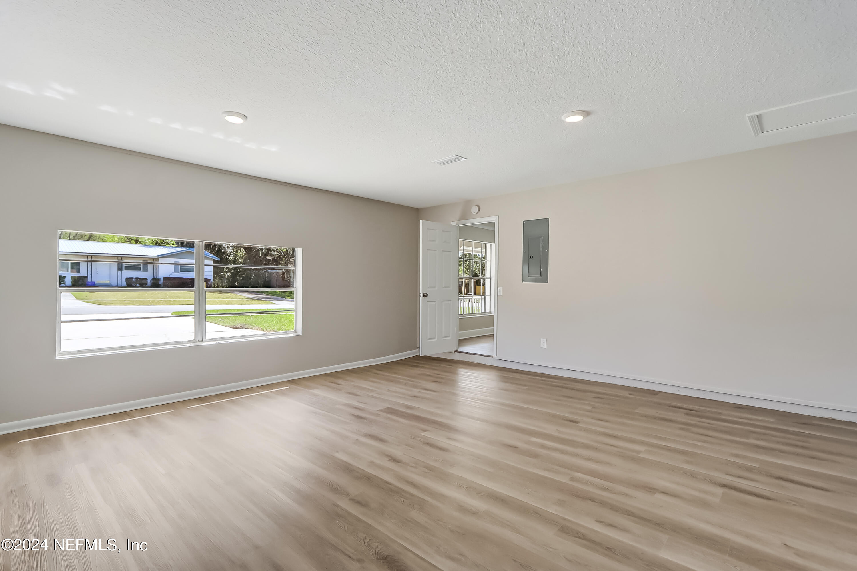 327 Neptune Road Orange Park, FL 32073 - Photo 30 of 40 an empty room with wooden floor and windows