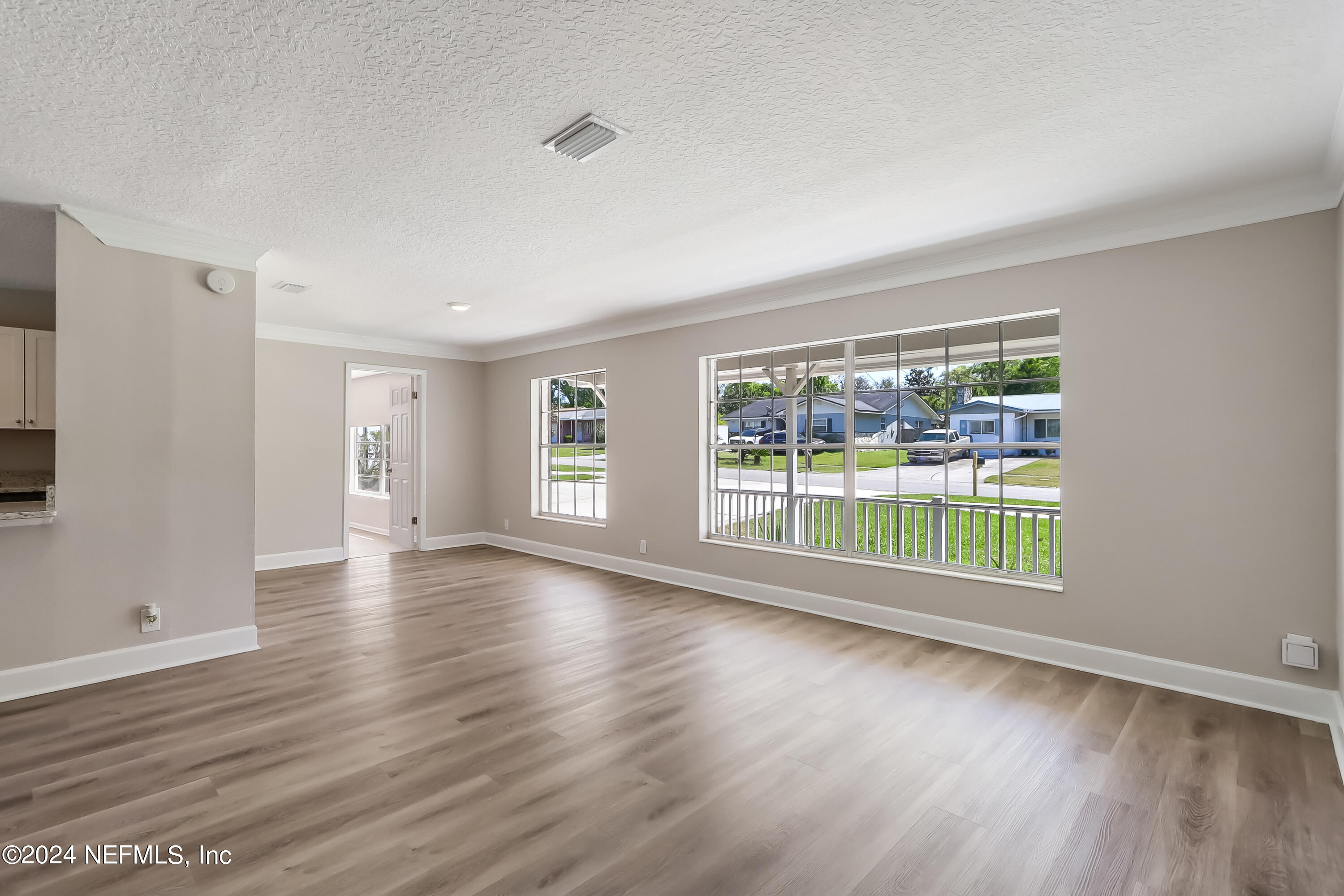 327 Neptune Road Orange Park, FL 32073 - Photo 3 of 40 a view of empty room with wooden floor and fan