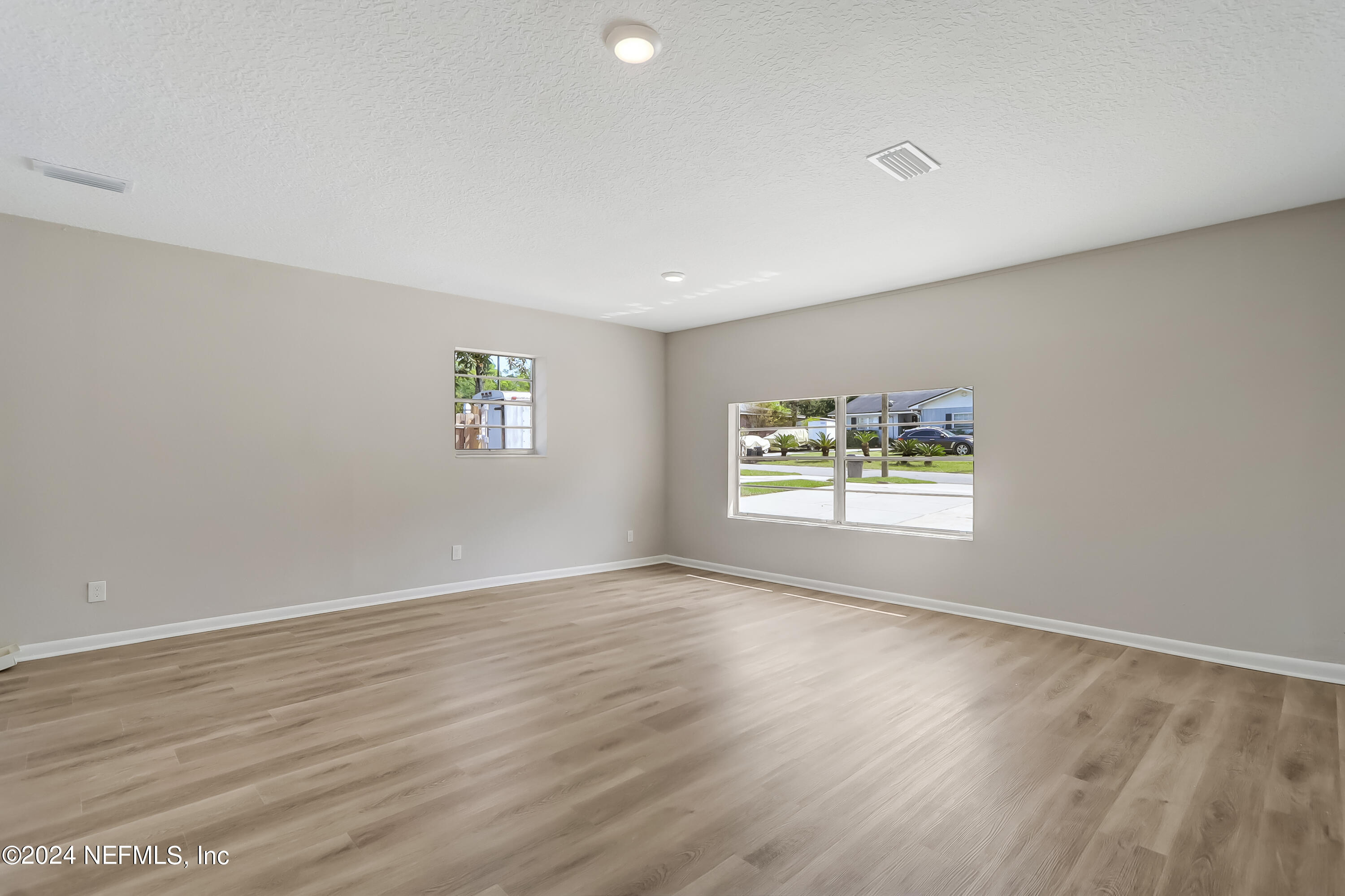 327 Neptune Road Orange Park, FL 32073 - Photo 33 of 40 wooden floor in an empty room with a window