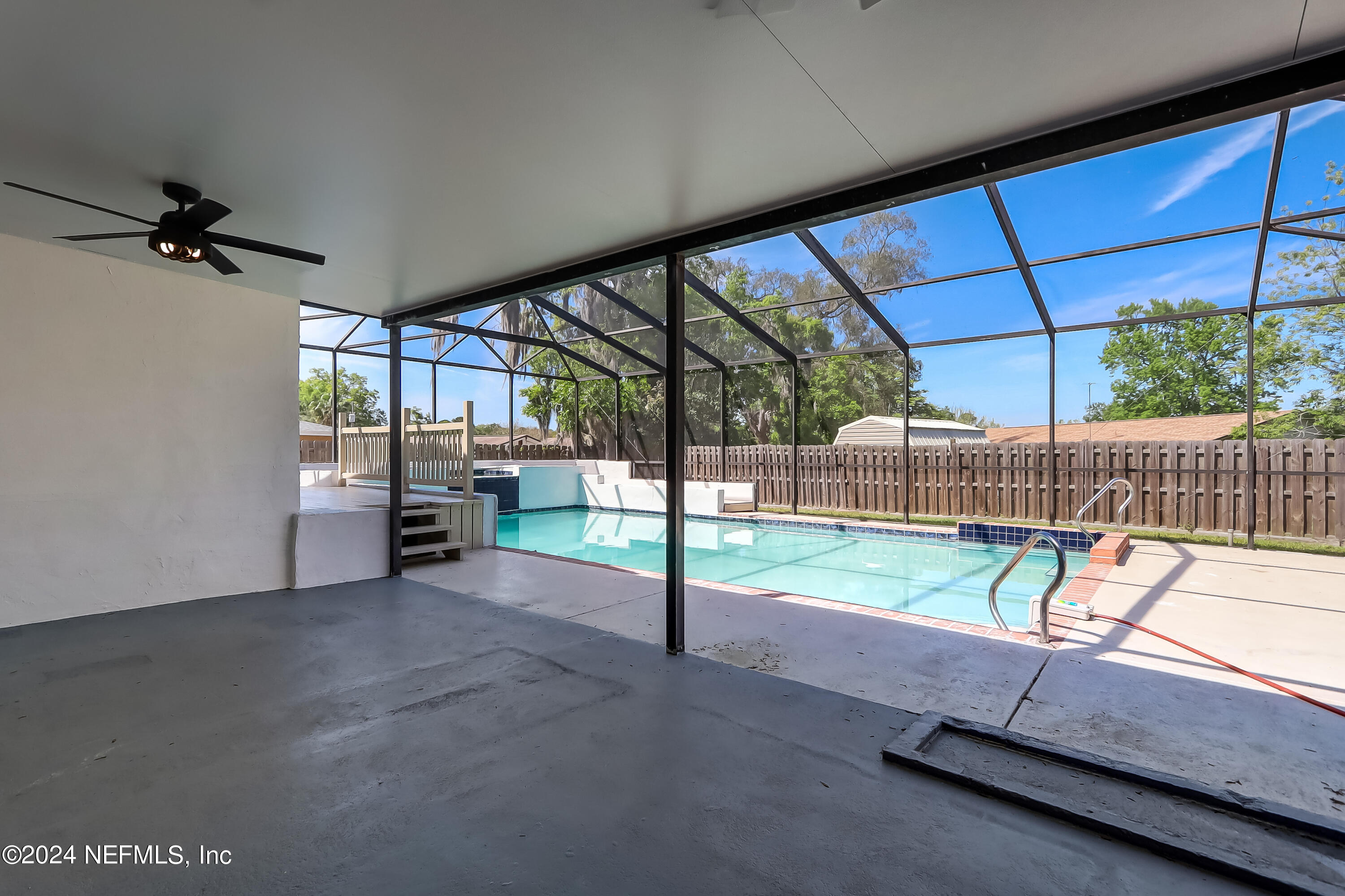 327 Neptune Road Orange Park, FL 32073 - Photo 35 of 40 a view of a room with wooden floor and iron stairs