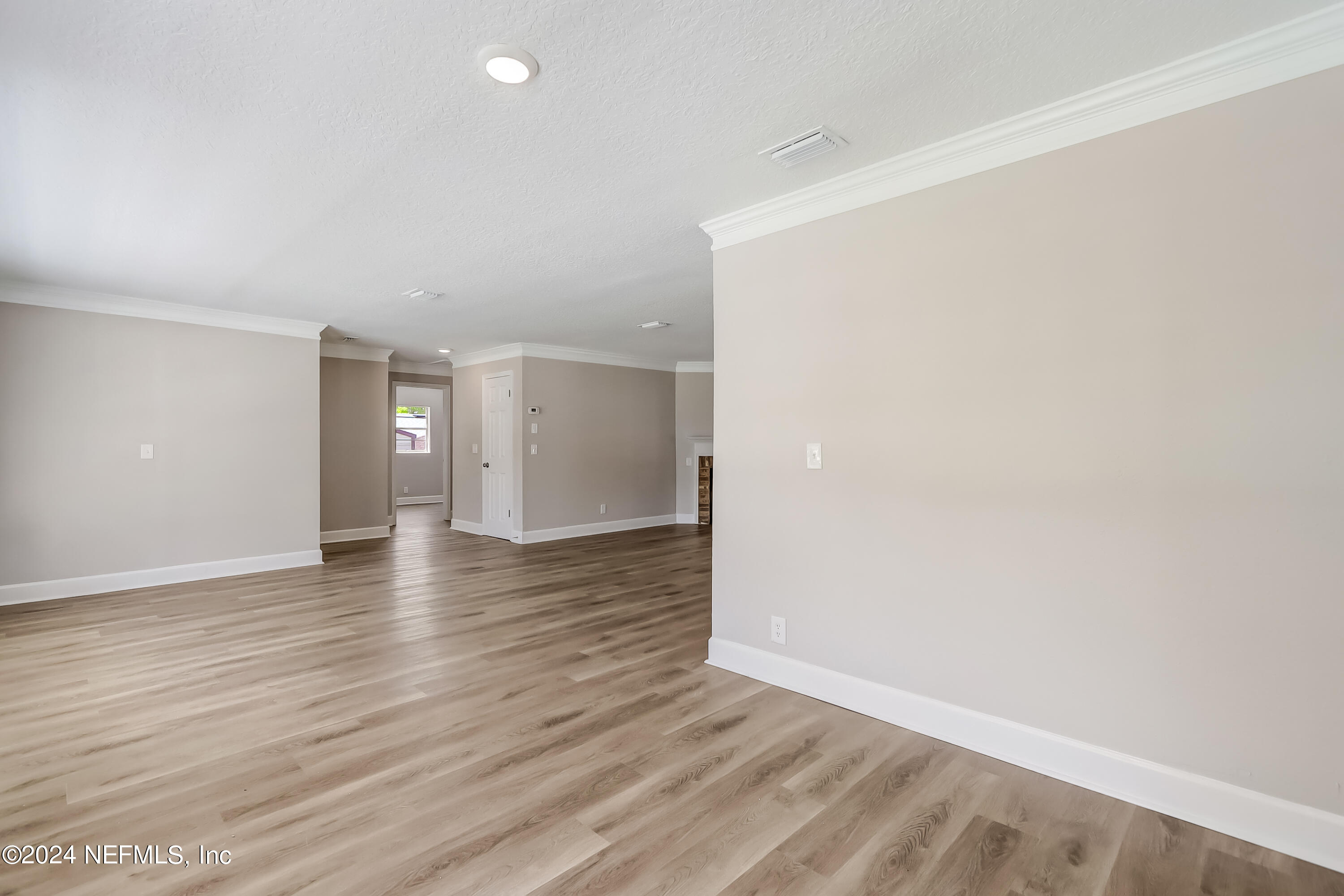327 Neptune Road Orange Park, FL 32073 - Photo 5 of 40 wooden floor in an empty room