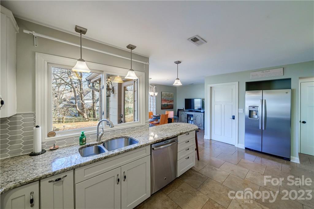 3942 Rounding Run Road Charlotte, NC 28277 - Photo 11 of 29 a kitchen with granite countertop a sink stainless steel appliances and cabinets