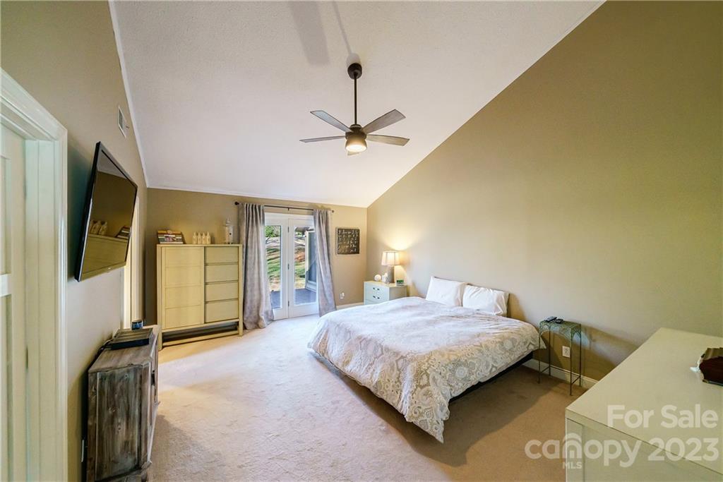 3942 Rounding Run Road Charlotte, NC 28277 - Photo 14 of 29 a bedroom with a bed and a chandelier