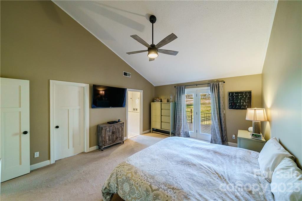 3942 Rounding Run Road Charlotte, NC 28277 - Photo 15 of 29 a bedroom with a bed and a flat screen tv