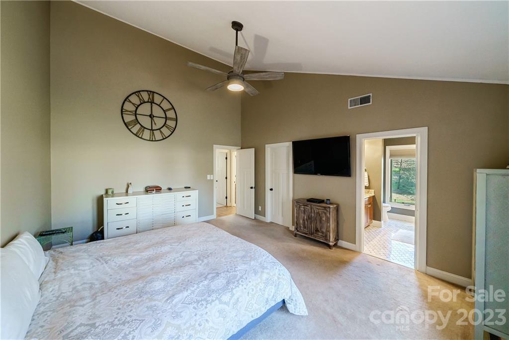 3942 Rounding Run Road Charlotte, NC 28277 - Photo 16 of 29 a bedroom with a large bed and a flat tv screen on the dresser