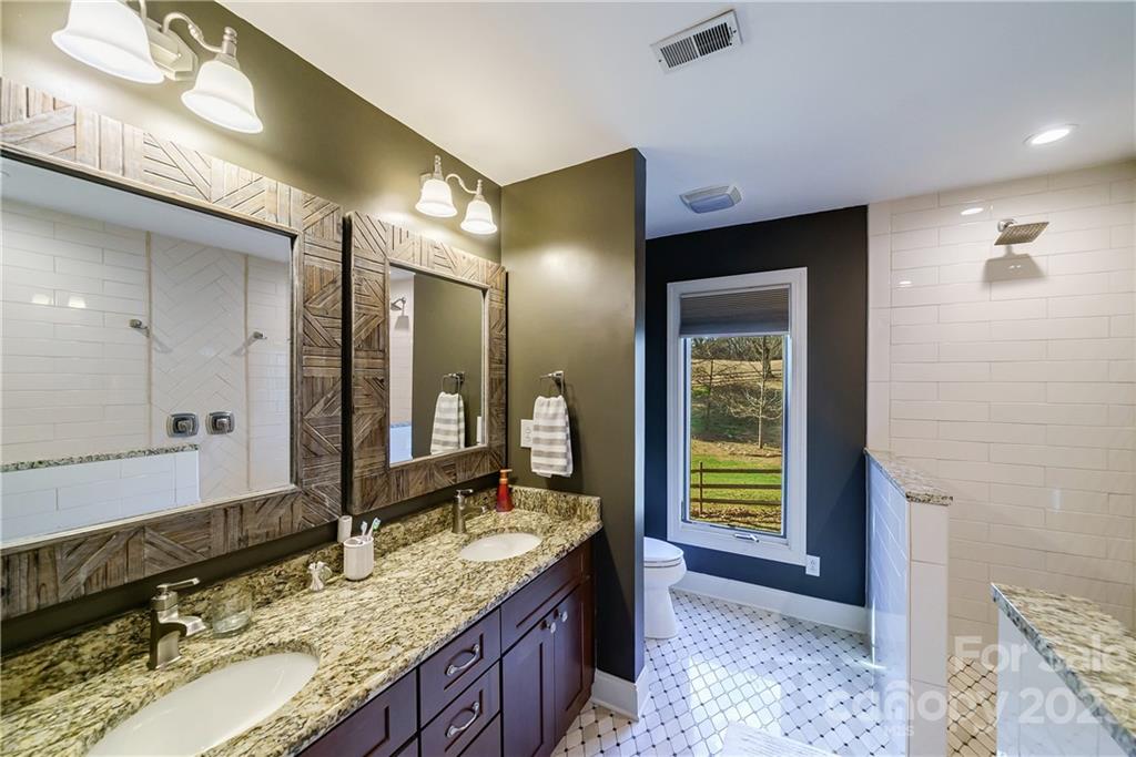 3942 Rounding Run Road Charlotte, NC 28277 - Photo 17 of 29 a bathroom with a granite countertop sink and a mirror