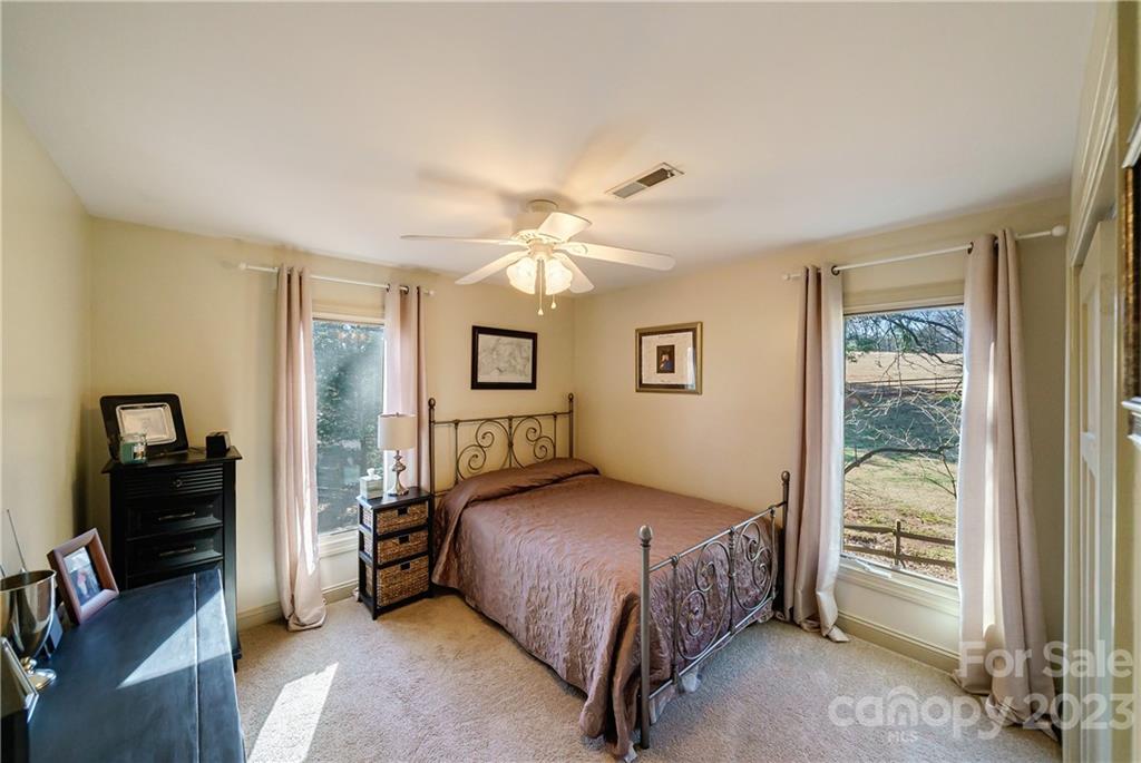 3942 Rounding Run Road Charlotte, NC 28277 - Photo 21 of 29 a bedroom with a bed and a chandelier