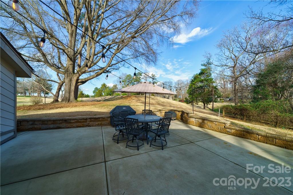 3942 Rounding Run Road Charlotte, NC 28277 - Photo 26 of 29 a backyard of a house with table and chairs