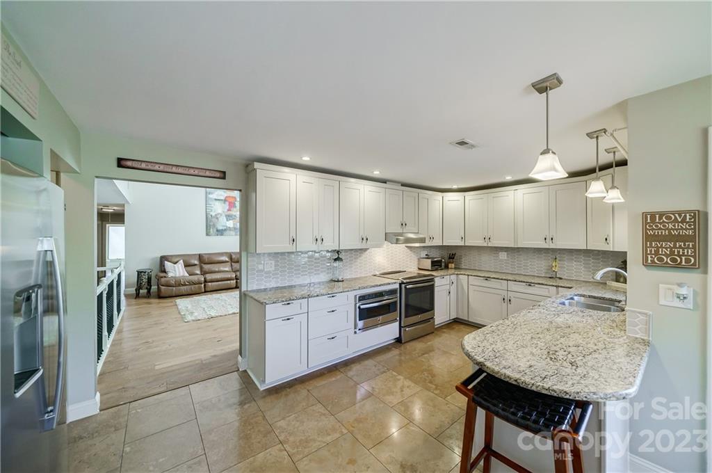 3942 Rounding Run Road Charlotte, NC 28277 - Photo 8 of 29 a kitchen with white cabinets and stainless steel appliances