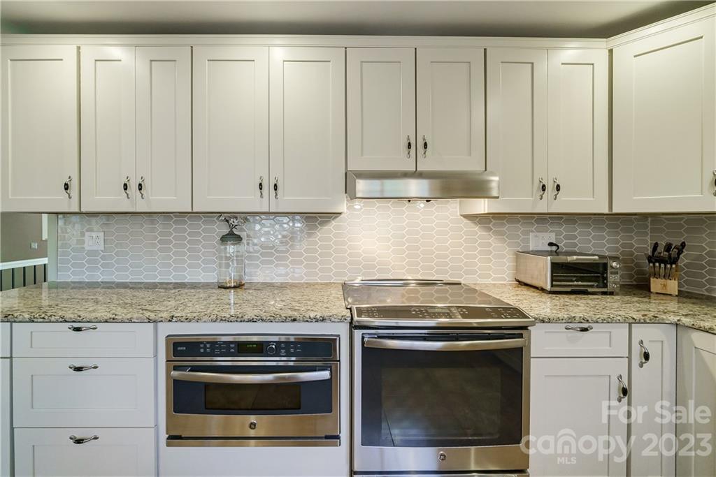 3942 Rounding Run Road Charlotte, NC 28277 - Photo 9 of 29 a kitchen with granite countertop white cabinets and stainless steel appliances