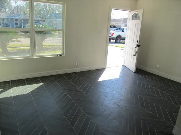 a room with wooden floor and window