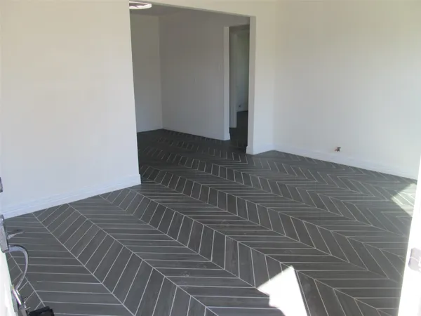 a view of a room with wooden floor