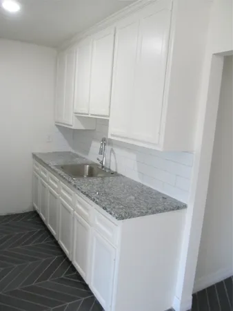 a kitchen with stainless steel appliances granite countertop a sink and dishwasher with wooden floor