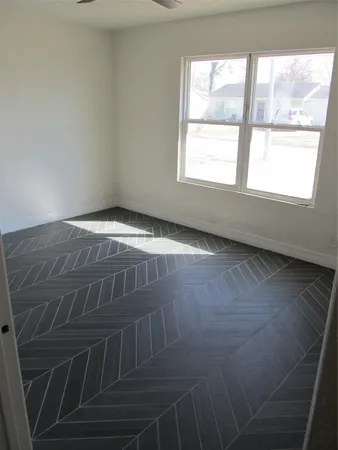 a view of wooden floor and window in a room