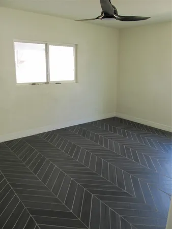 a view of a room with wooden floor and a window