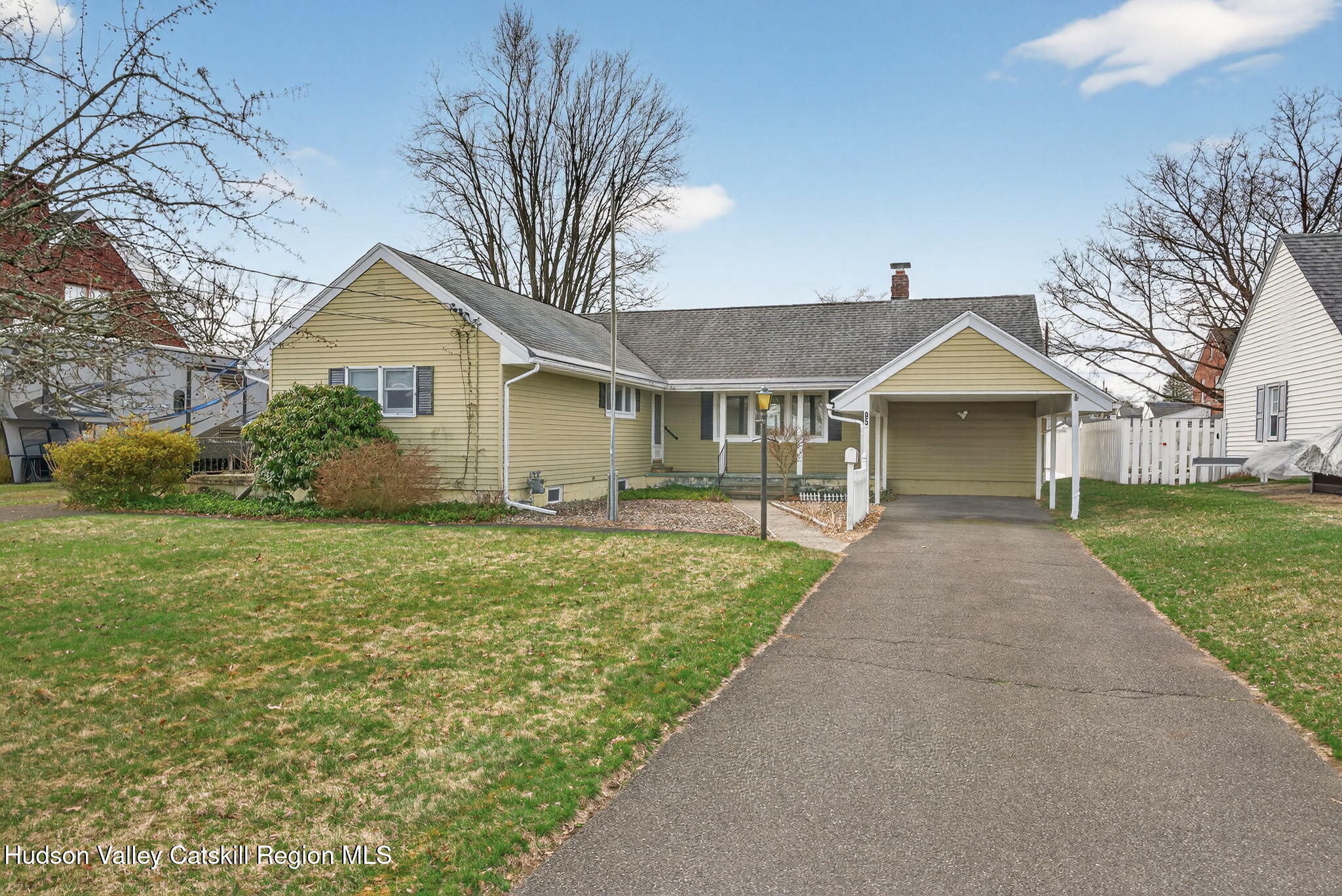 a front view of house with yard and green space