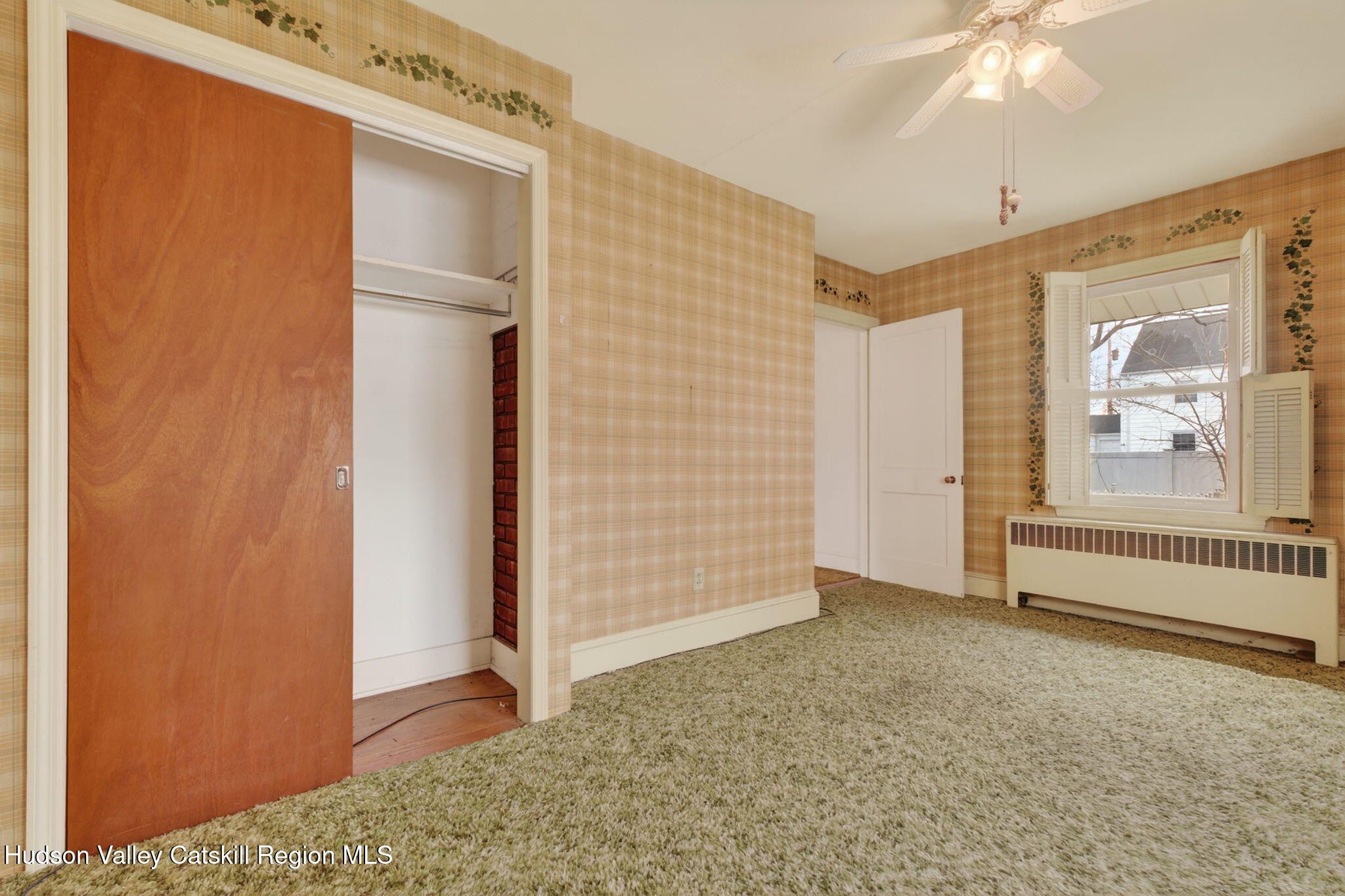 85 Harding Avenue Kingston, NY 12401 - Photo 29 of 41 an empty room with a walk in closet and wooden floor