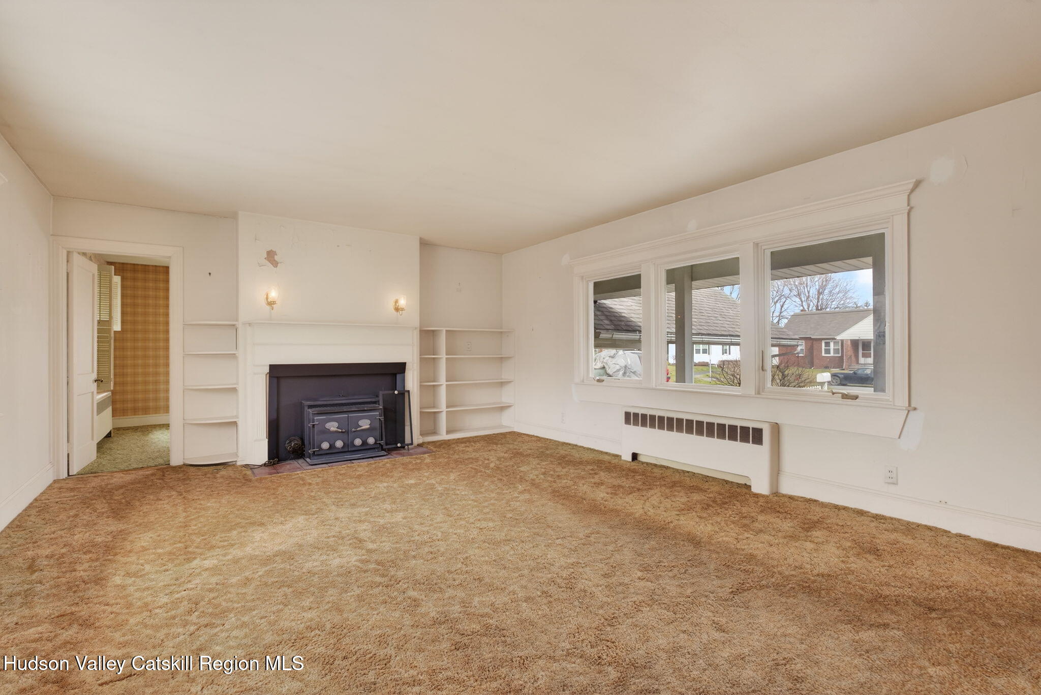 85 Harding Avenue Kingston, NY 12401 - Photo 4 of 41 an empty room with fireplace and windows