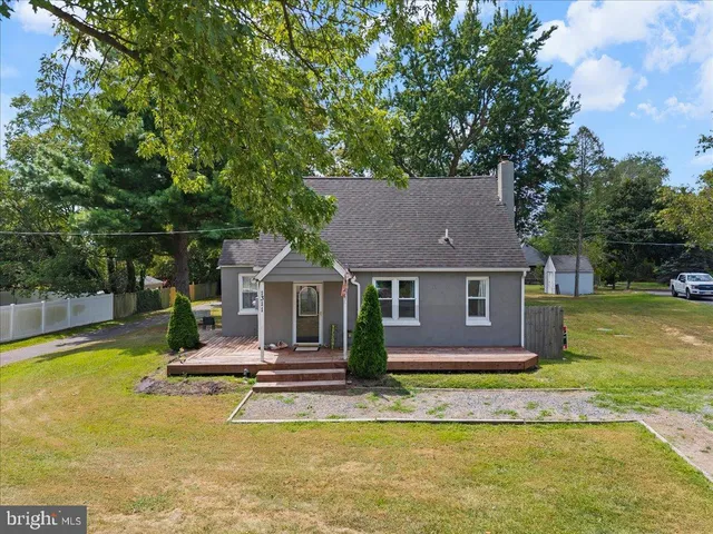 a view of house with swimming pool and yard