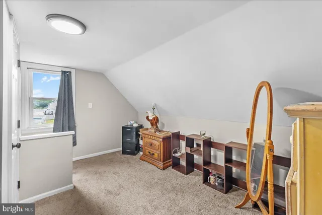 a view of a bedroom with window and furniture
