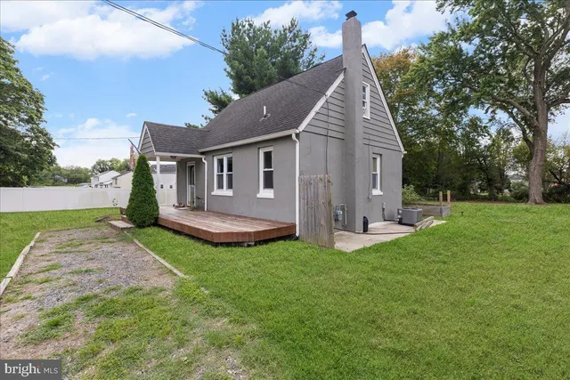 a view of a house with a yard and deck
