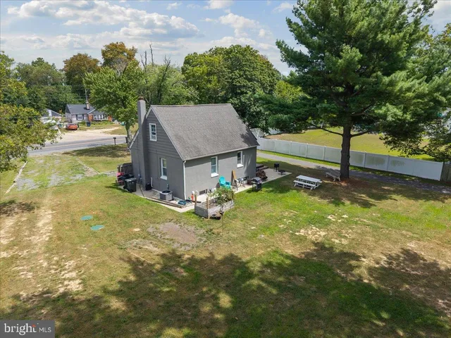 a house view with swimming pool and trees