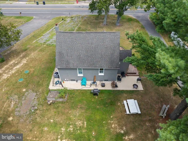 a aerial view of a house with swimming pool and sitting area